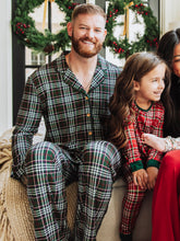 Get cozy in timeless holiday style with our Menโs Holiday Plaid Pajama Set. Designed for comfort and classic charm, this two-piece set features a button-down long sleeve top and relaxed-fit pants in a festive green, red, and white plaid pattern. Made from ultra-soft, breathable fabric, itโs perfect for lounging, sleeping, or matching family Christmas mornings.